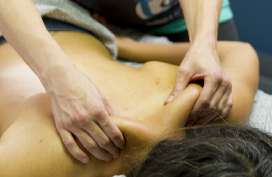 Urban Squeeze massage therapist pinching a client’s shoulders